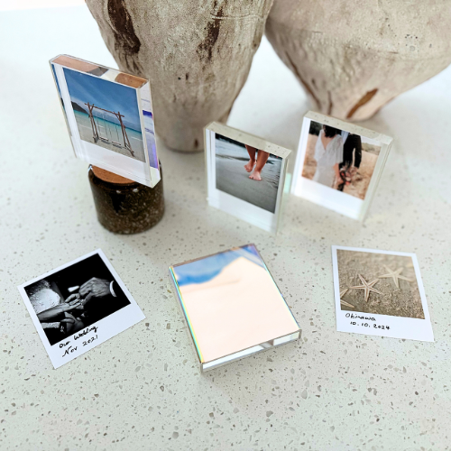 Mini acrylic photo frame with iridescent sides, designed to display 2R or Polaroid photos. Features a seamless sliding mechanism for easy photo insertion.