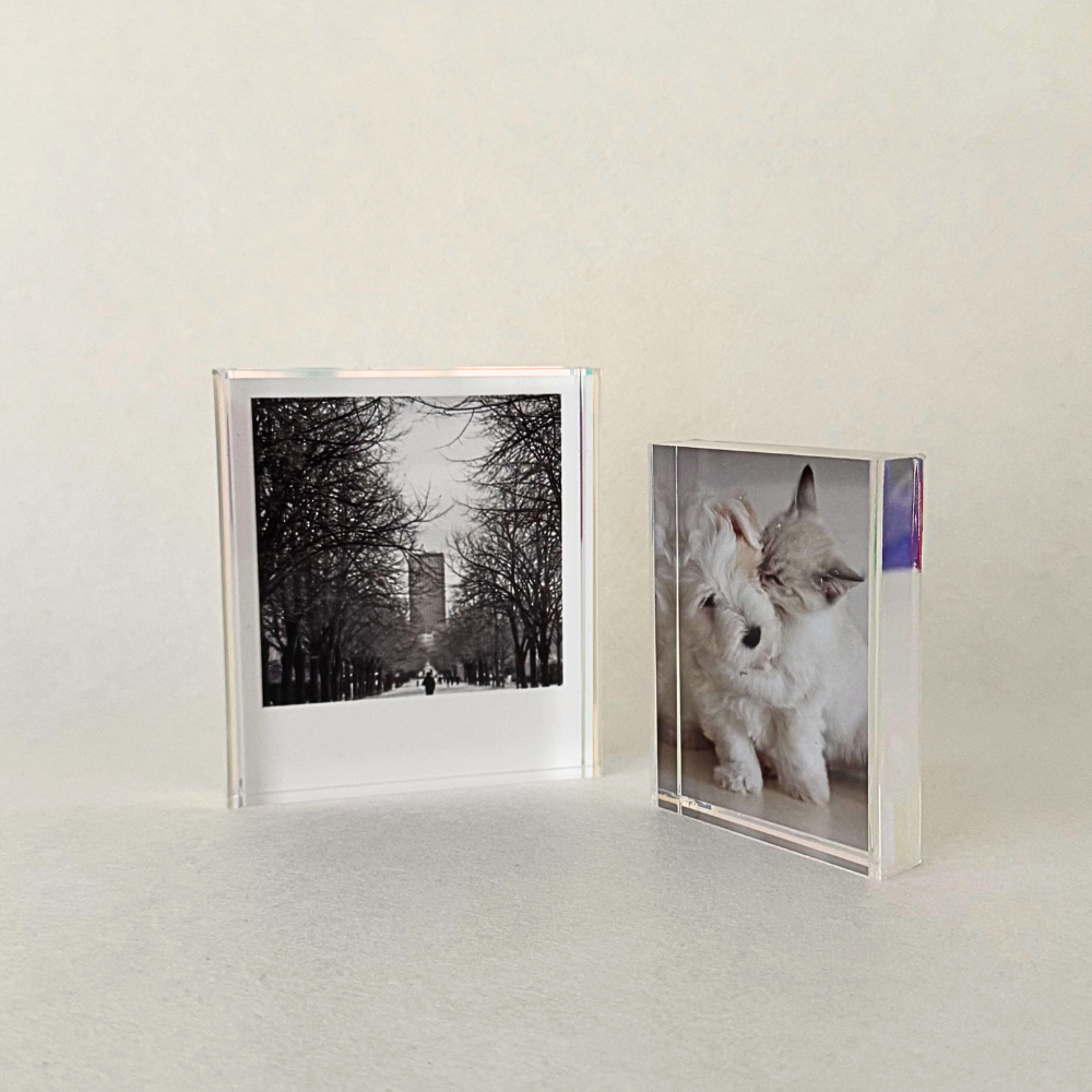 Mini acrylic photo frame with iridescent sides, designed to display 2R or Polaroid photos. Features a seamless sliding mechanism for easy photo insertion.