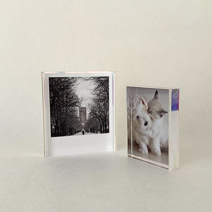 Mini acrylic photo frame with iridescent sides, designed to display 2R or Polaroid photos. Features a seamless sliding mechanism for easy photo insertion.